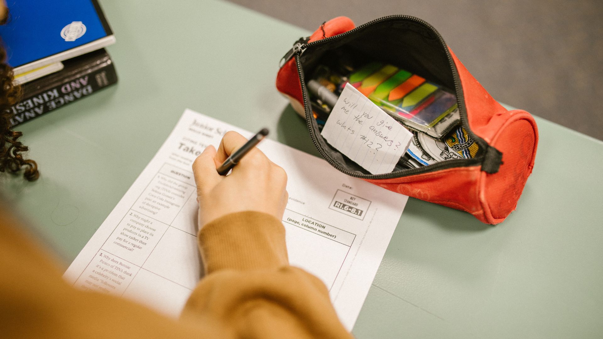 A student taking an exam and cheating.